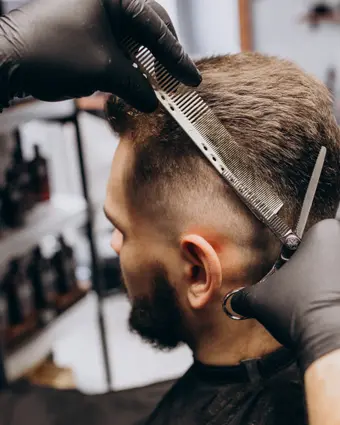 Clipper taper being worked through the back of a client's hair