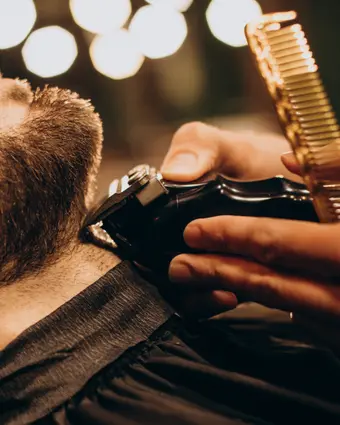 Straight-razor beard line-up during a grooming appointment